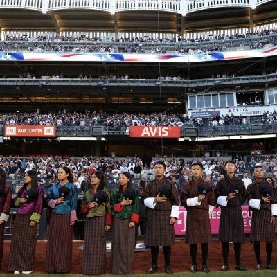 NEW YORK, NY - AUGUST 21: Players from the Bhutan Baseball and Softball Association (BBSA) stand for the national anthem before the game between the New York Yankees and the Cleveland Guardians at Yankee Stadium on August 21, 2024, in New York, New York. (Photo by New York Yankees/Getty Images)
